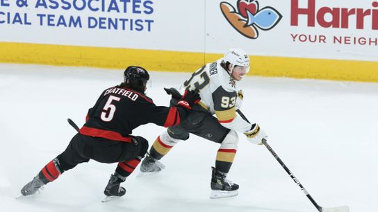 Jun 4, 2026; Raleigh, North Carolina, USA; Vegas Golden Knights right wing Mitch Marner (93) controls the puck against Carolina Hurricanes defenseman Jalen Chatfield (5) during the third period in game two of the 2026 Stanley Cup Final at Lenovo Center. 