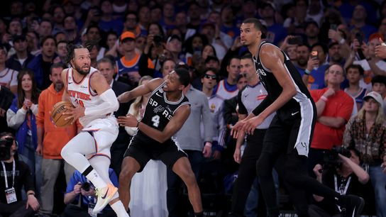 Jun 10, 2026; New York, New York, USA; New York Knicks guard Jalen Brunson (11) controls the ball against San Antonio Spurs guard De'aaron Fox (4) and forward Victor Wembanyama (1) during the fourth quarter of game four of the 2026 NBA Finals at Madison Square Garden. 