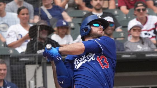Los Angeles Dodgers third baseman Max Muncy (13) hits a two-run homer against the Chicago White Sox during the first inning at Rate Field. 