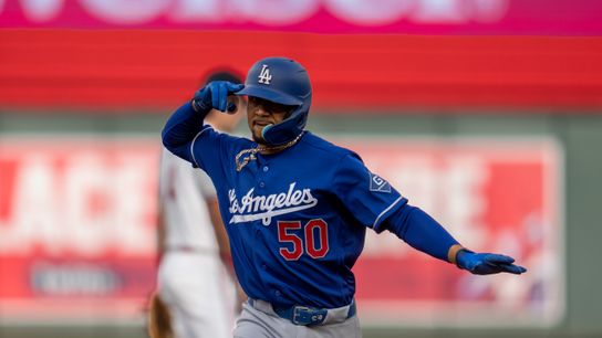 Los Angeles Dodgers shortstop Mookie Betts (50) reacts while rounding the bases after hitting a solo home run against the Minnesota Twins in the first inning at Target Field. 