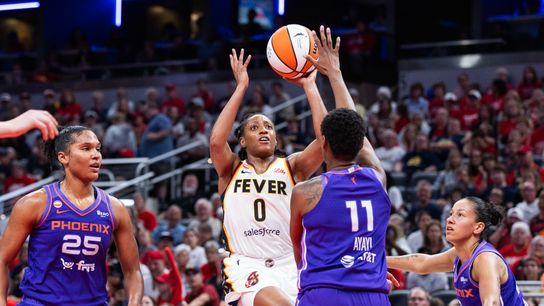 Jun 24, 2026; Indianapolis, Indiana, USA; Indiana Fever guard Kelsey Mitchell (0) shoots the ball while Phoenix Mercury forward Valeriane Ayayi (11) defends in the second half at Gainbridge Fieldhouse. 
