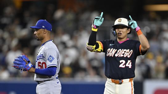 San Diego Padres second baseman Sung-Mun Song (24) gestures after hitting an RBI single as Los Angeles Dodgers shortstop Mookie Betts (50) looks on during the eighth inning at Petco Park. 