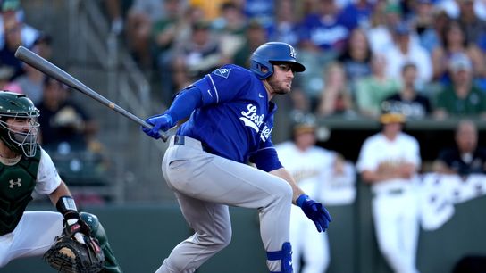 Los Angeles Dodgers third baseman Max Muncy (13) hits an RBI single against the Athletics in the second inning at Sutter Health Park. 