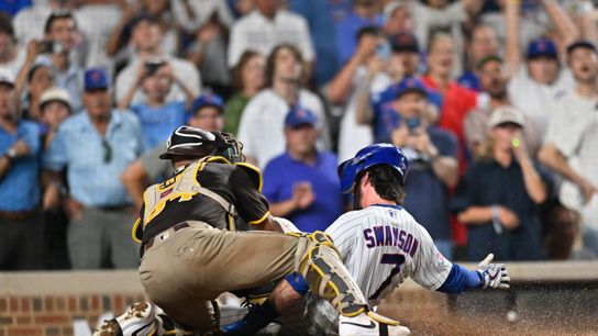 Jun 29, 2026; Chicago, Illinois, USA; Chicago Cubs shortstop Dansby Swanson (7) is tagged out at home plate against San Diego Padres catcher Freddy Fermin (54) during the ninth inning at Wrigley Field.