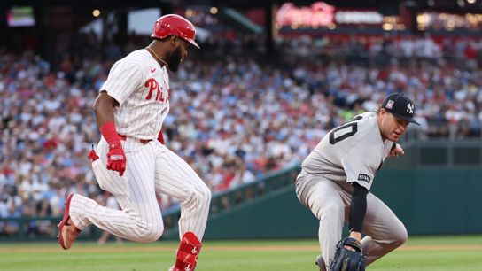 Jul 25, 2026; Philadelphia, Pennsylvania, USA; Philadelphia Phillies outfielder Bryan de la Cruz (41) beats out the tag attempt by New York Yankees pitcher Ryan Weathers (40) at first base during the sixth inning at Citizens Bank Park. 
