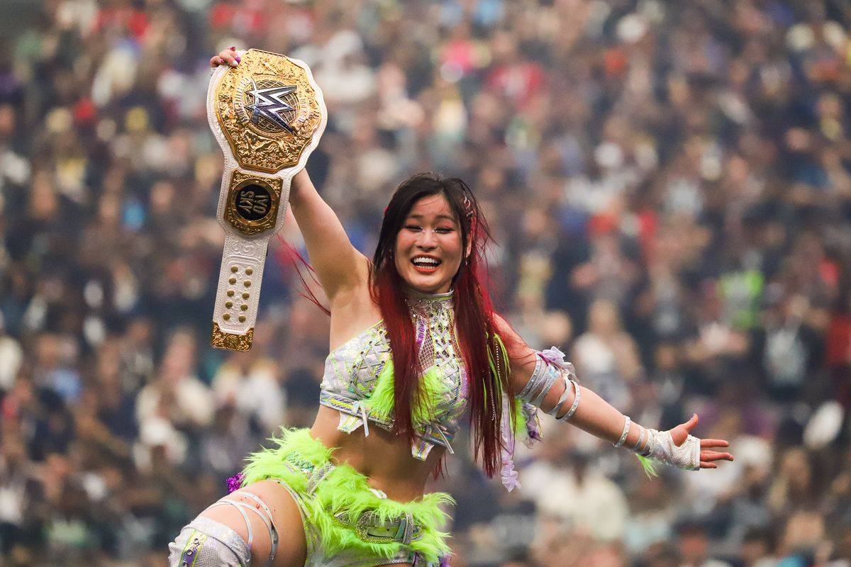 Iyo Sky holds the championship belt towards the crowd after defeating Rhea Ripley and Bianca Blair in the Women’s World Championship during WrestleMania 41 In Las Vegas on Sunday April 20, 2025.