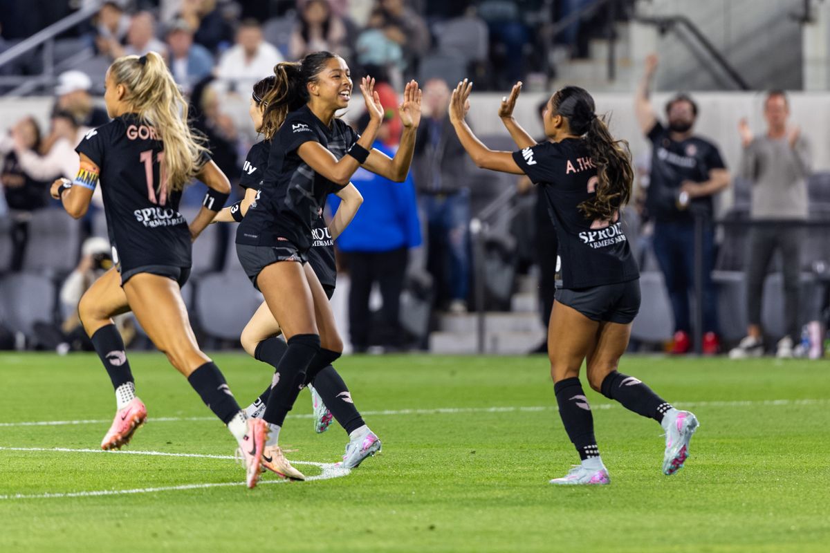 Angel City FC attacker Alyssa Thompson (21) and midfielder Madison Hammond (99) celebrate the 100th regular season goal in Angel City FC franchise history during an NWSL match against Racing Louisville FC, Saturday May 24, 2025 in Los Angeles, Calif.