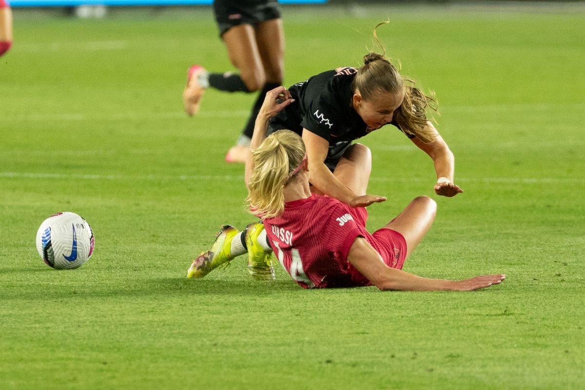 Angel City FC forward Julie Dufour (7) gets tangled up with an opponent at an NWSL game against the NC Courage  on Saturday June 14th, 2025 in Los Angeles, California. 