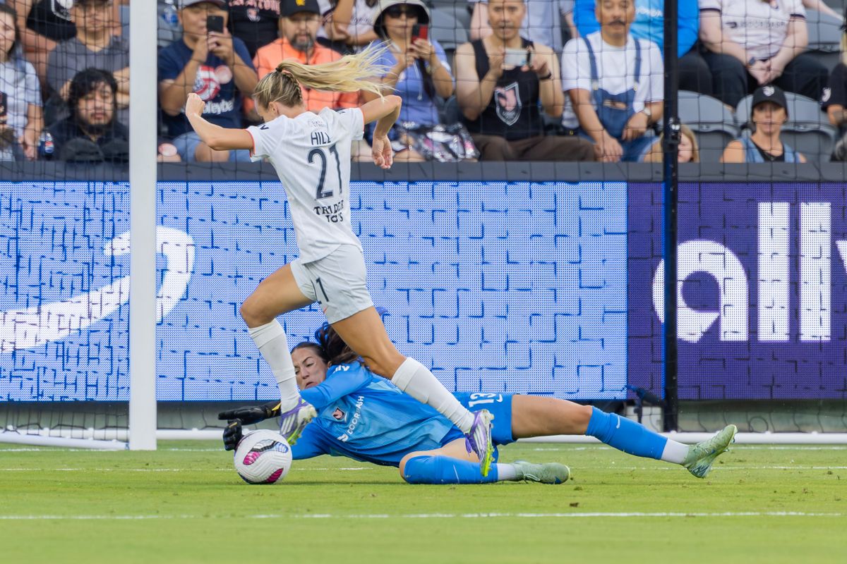 Hannah Seabert #13 of Angel City FC makes a diving save against Rachel Hill #21 of Bay FC during an NWSL match at BMO Stadium on September 1, 2025 in Los Angeles, California.