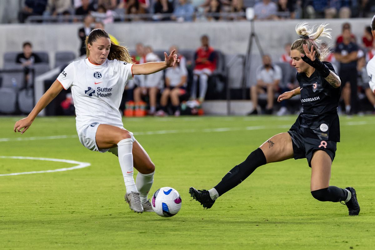 Caroline Conti #15 of Bay FC and Macey Hodge #8 of Angel City FC reach for the ball during an NWSL match at BMO Stadium on September 1, 2025 in Los Angeles, California.