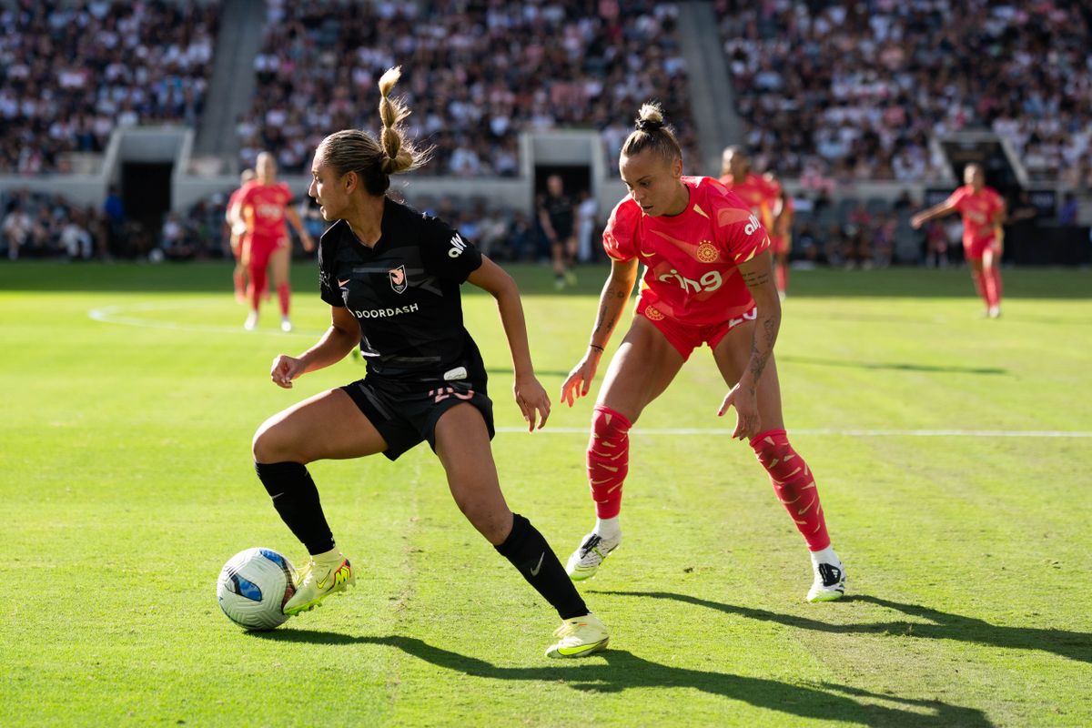 Angel City FC midfielder Gisele Thompson (20) protects the ball against a Portland Thorns player, Sunday, Oct. 19, 2025, at BMO Stadium in Los Angeles.Angel City FC defender Gisele Thompson protects the ball against a Portland Thorns player, Sunday, Oct. 19, 2025, at BMO Stadium in Los Angeles, Calif