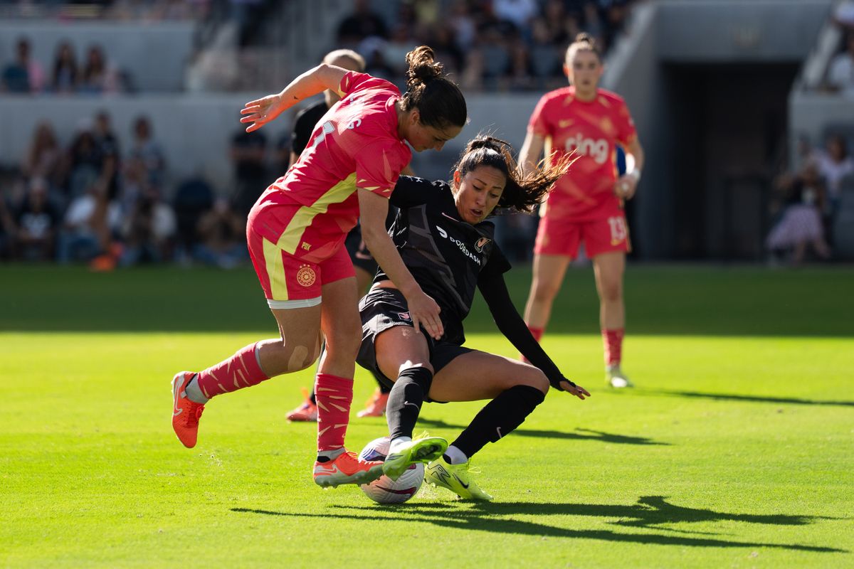 Angel City FC forward Christen Press (23) steals the ball from a Portland Thorns player, Sunday, Oct. 19, 2025, at BMO Stadium in Los Angeles, Calif.