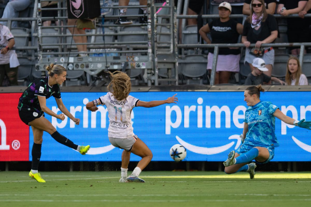 Angel City FC goalkeeper Angelina Anderson (19) attempts to block a shot from Racing Louisville forward Kayla Fischer (9) during an NWSL match between Racing Louisville FC and Angel City FC on Sunday, July 27, 2026 at BMO Stadium, Los Angeles Calif