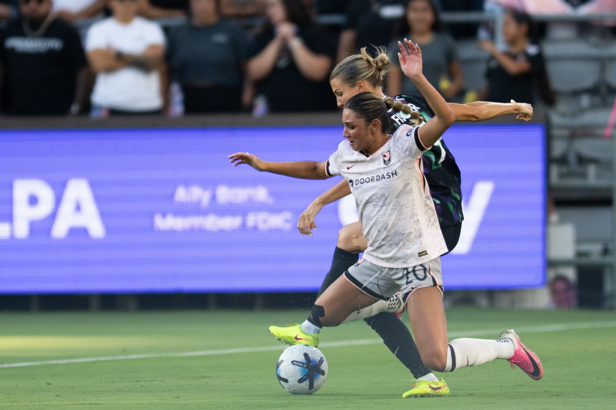Angel City FC forward Gisele Thompson (20) gets tackled during an NWSL match between Racing Louisville FC and Angel City FC on Sunday, July 27, 2026 at BMO Stadium, Los Angeles Calif