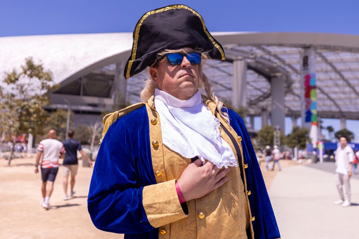 A United States fan dressed as George Washington stands at attention outside of SoFi Stadium before a 2026 FIFA World Cup match between the United States and Paraguay, Friday June 12, 2026 in Inglewood, Calif.
