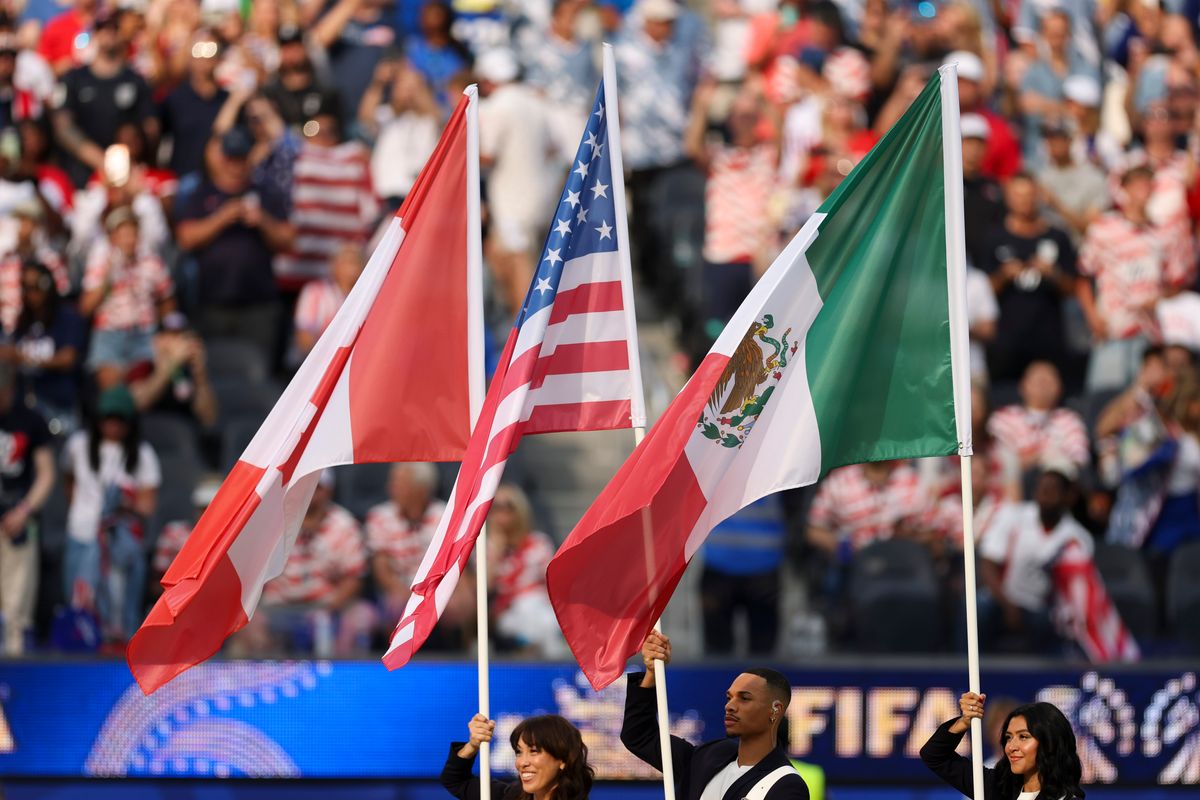 The flags of the host countries of the 2026 FIFA World Cup, Canada, the United States, and Mexico,  are brought onto the field before a group stage match between the United States and Paraguay, Friday June 12, 2026 in Inglewood, Calif.
