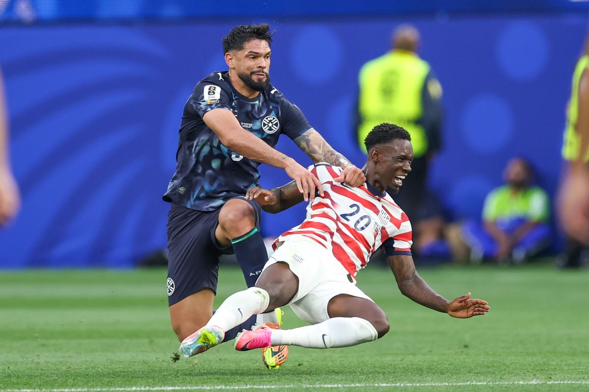 Omar Alderete #3 of Paraguay pushes Folarin Balogun #20 of United States to the ground during a 2026 FIFA World Cup match, Friday June 12, 2026 in Inglewood, Calif.