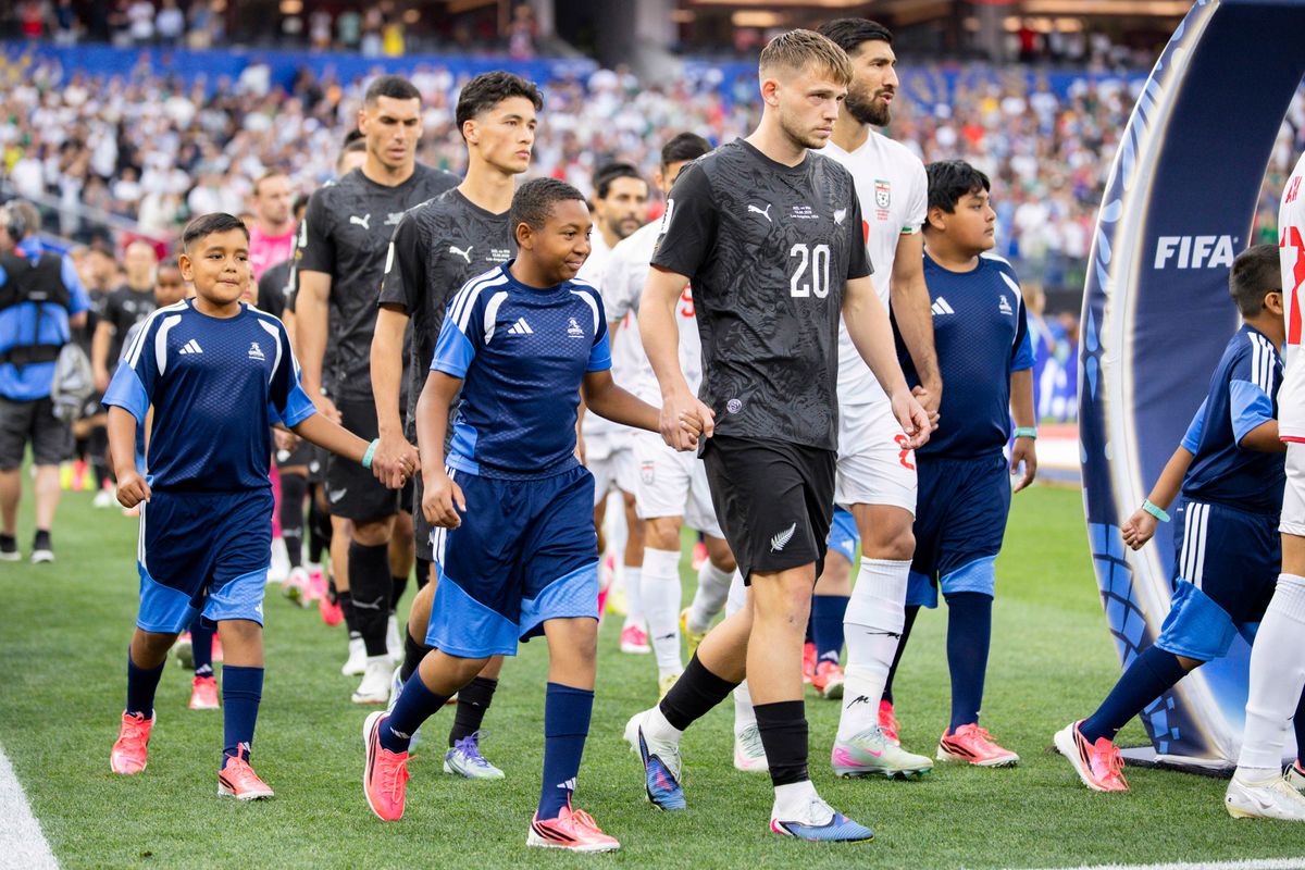 Iran and New Zealand players walk onto the pitch before their 2026 FIFA World Cup match, Monday June 15, 2026 in Inglewood, Calif.