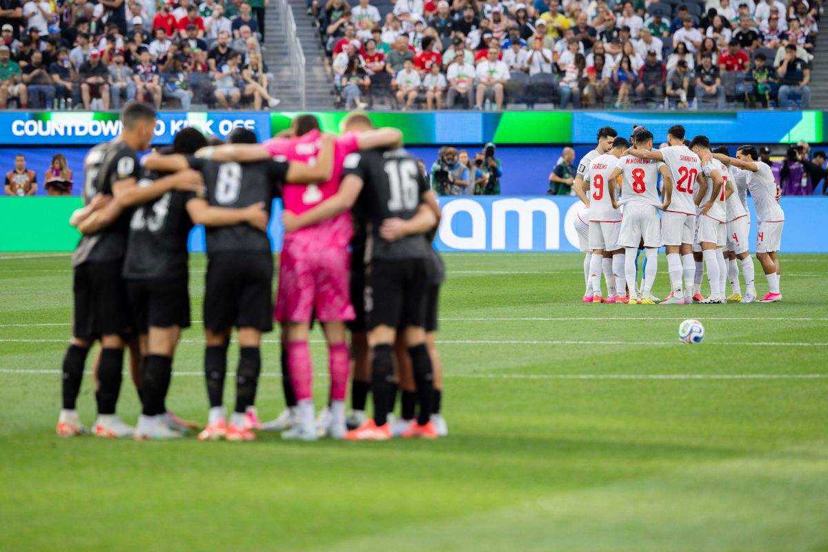 Iran and New Zealand’s starting XI huddle on the pitch before their 2026 FIFA World Cup match, Monday June 15, 2026 in Inglewood, Calif.