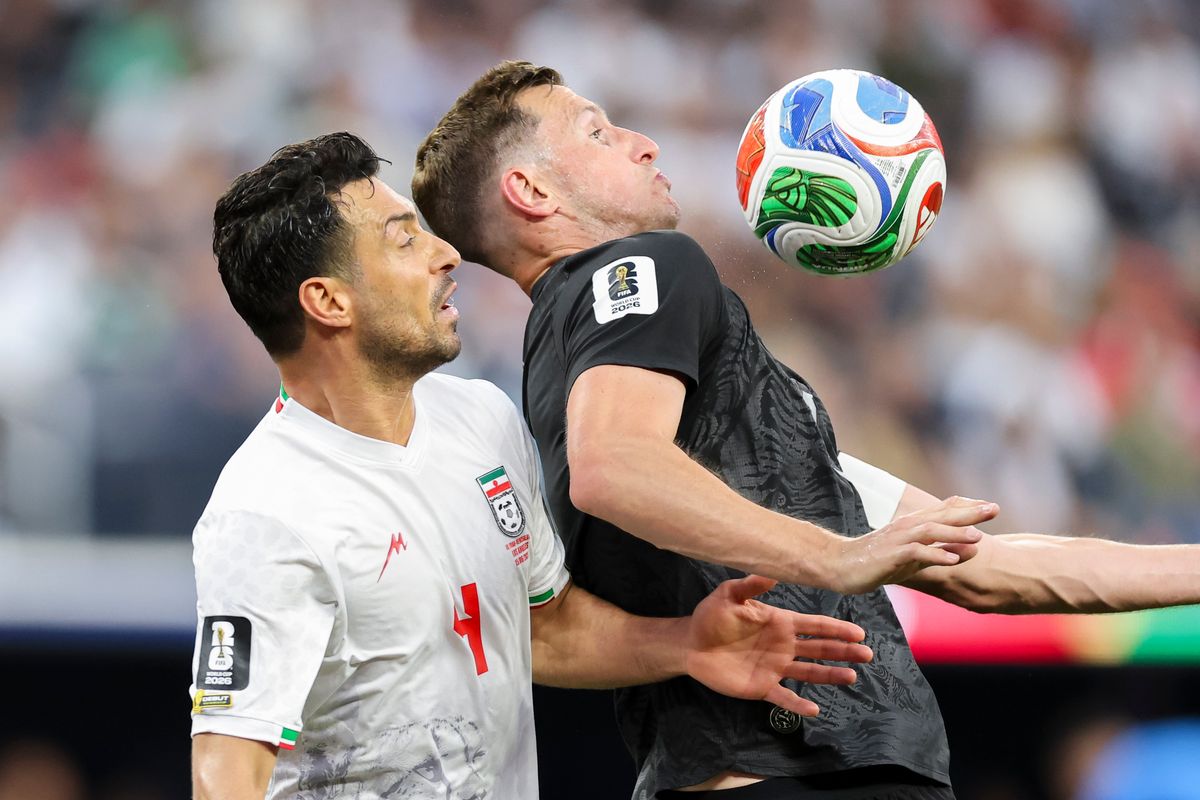Shoja Khalilzadeh #4 of Iran and Chris Wood #9 of New Zealand battle for the ball during a 2026 FIFA World Cup match, Monday June 15, 2026 in Inglewood, Calif.
