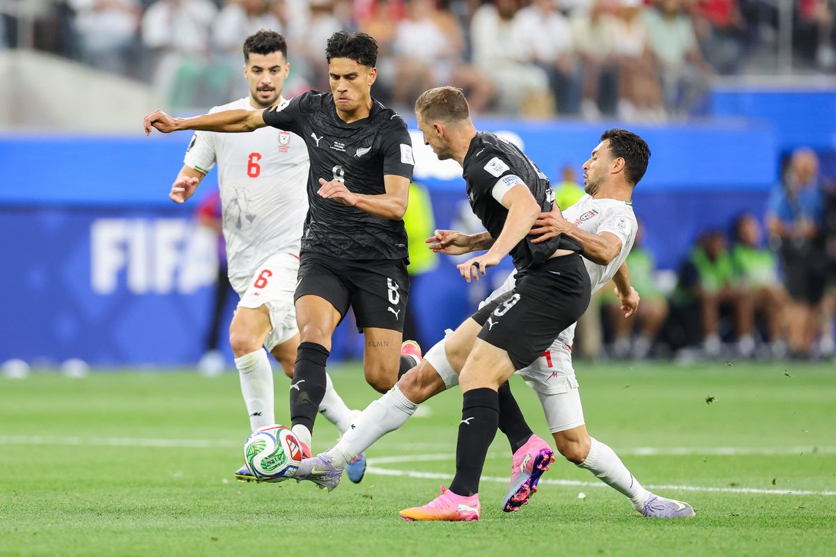 Shoja Khalilzadeh #4 of Iran battles for the ball with Marko Stamenić #8 and Chris Wood #9 of New Zealand during a 2026 FIFA World Cup match, Monday June 15, 2026 in Inglewood, Calif.
