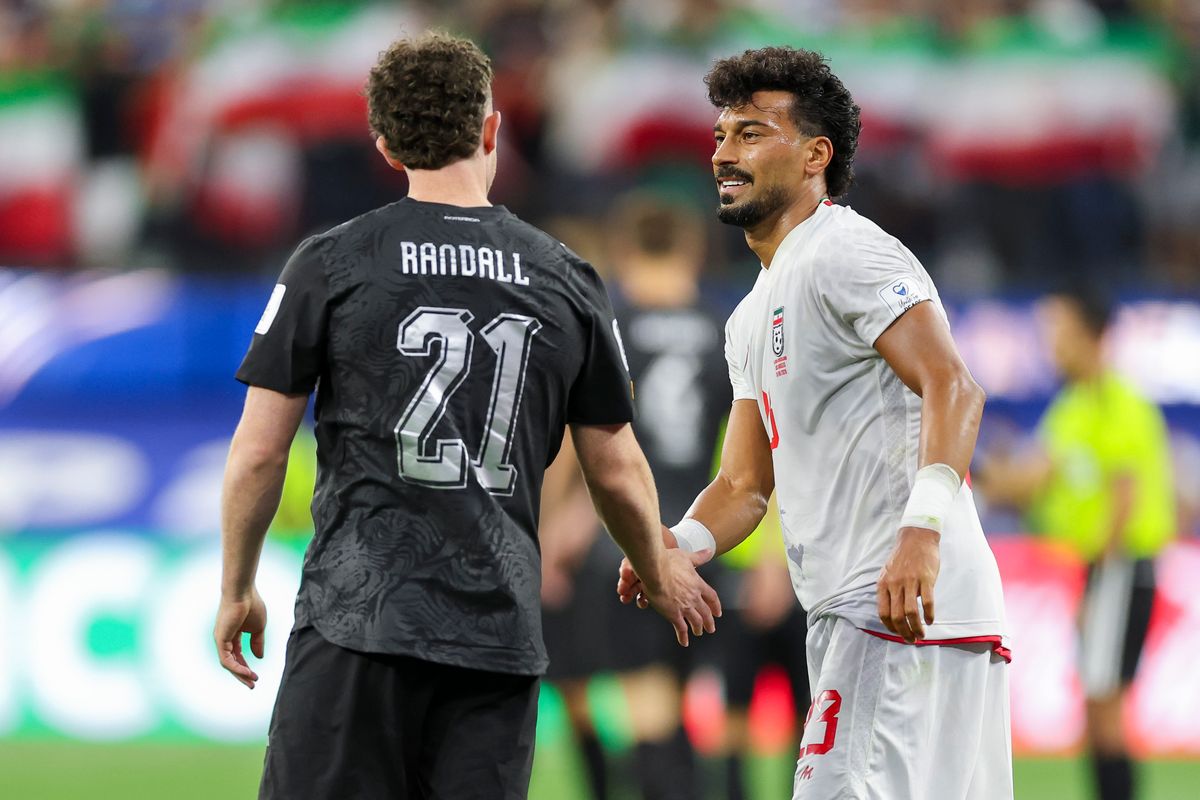 Jesse Randall #21 of New Zealand and Ramin Rezaeian #23 of Iran shake hands after their 2026 FIFA World Cup match, Monday June 15, 2026 in Inglewood, Calif. 