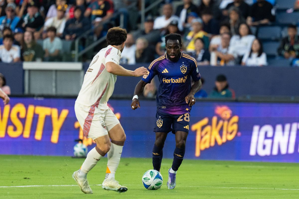 Los Angeles Galaxy forward Joseph Paintsill (28) dribbles by a defender during an MLS match against D.C. United, Saturday July 12, 2025 in Carson, Calif.