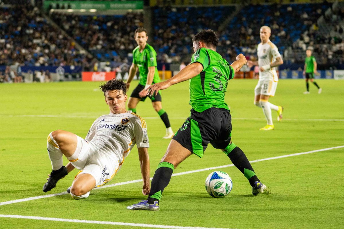 LA Galaxy central midfielder Isaiah Parentes (16) goes for the sliding tackle at an MLS game against Austin FC on July 16th, 2025 in Carson, California