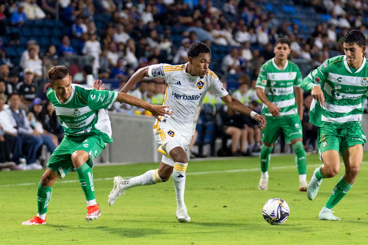 Los Angeles Galaxy defender Mauricio Cuevas (19) splits the defenders during the Leagues Cup game against Santos Laguna, Thursday August 7th, 2025 in Carson, California. 