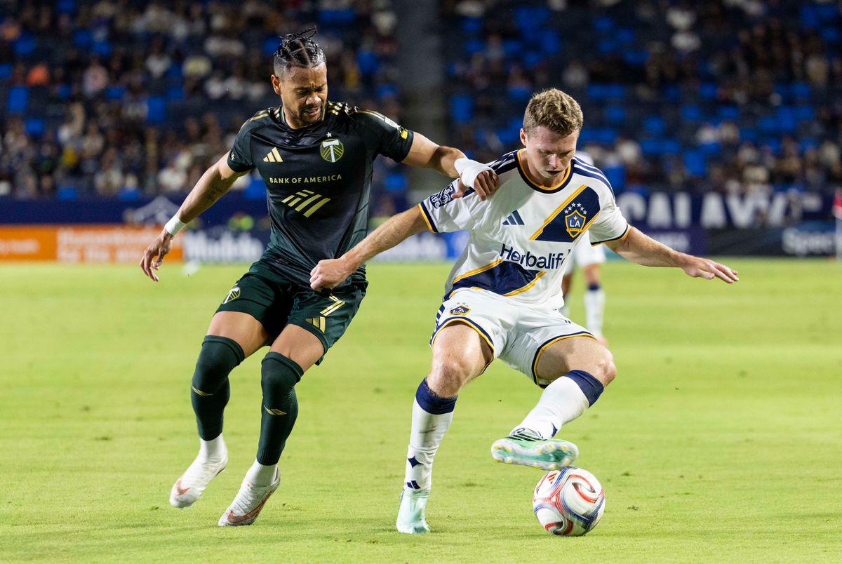 Los Angeles Galaxy defender John Nelson (14) runs with the ball during a MLS soccer game against Portland Timbers forward Ariel Lassiter (7), Wednesday October 14, 2026 in Carson, California. Los Angeles Galaxy defender John Nelson (14) runs with the ball during a MLS soccer game against Portland Timbers forward Ariel Lassiter (7), Wednesday October 14, 2026 in Carson, California.