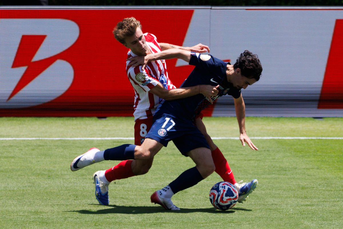 Vitinha #17 and Pablo Barrios #8 battle for the ball during the FIFA Club World Cup 2025 group B match between Paris Saint-Germain FC and Club Atletico de Madrid at Rose Bowl Stadium on June 15, 2025 in Pasadena, California.