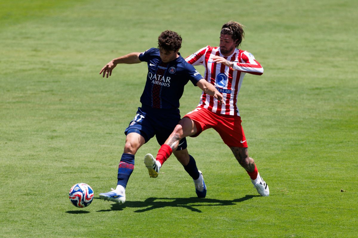 Rodrigo De Paul #5 and Vitinha #17 battle for the ball during the FIFA Club World Cup 2025 group B match between Paris Saint-Germain FC and Club Atletico de Madrid at Rose Bowl Stadium on June 15, 2025 in Pasadena, California.