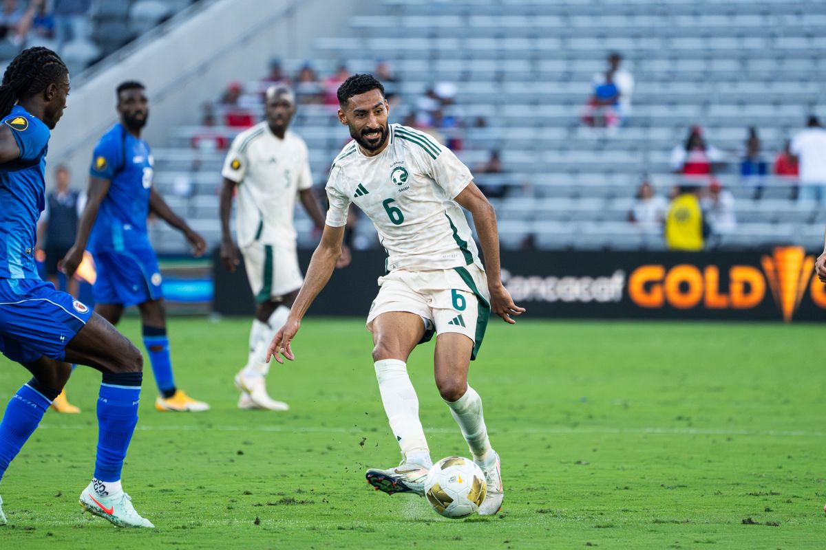 Saudi Arabia's Midfielder #6 Ali Al-Hassan fighting to keep the ball from defenders during a Gold Cup match vs Haiti on June 15, 2025 in San Diego, CA.