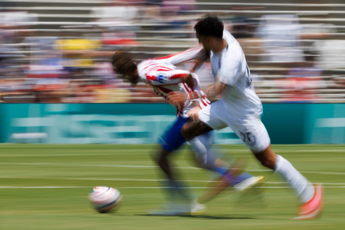 Alexander Barboza #20 of Botafogo battles for possession of the ball during the FIFA Club World Cup 2025 group B match against Atletico de Madrid at Rose Bowl Stadium on June 23, 2025 in Pasadena, California. 
