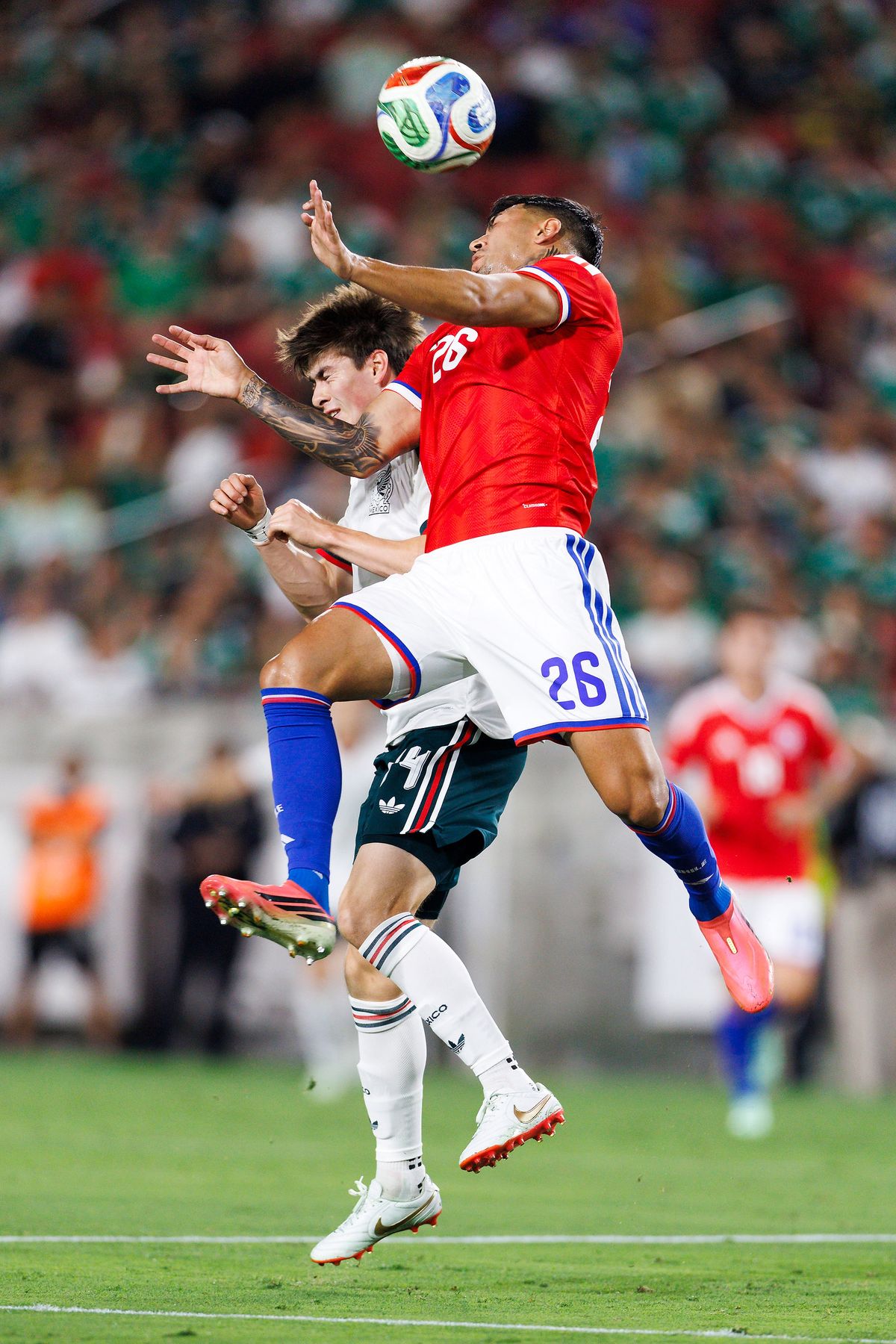 Diego Ulloa #26 of Chile heads the ball during the match against Mexico at Los Angeles Memorial Coliseum on October 6, 2026 in Los Angeles, California.