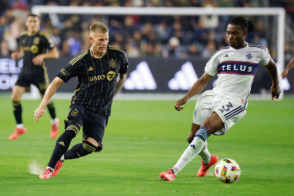 LAFC Midfielder Mateus Bogusz (19) runs past a defender before scoring a goal during match against the Vancouver Whitecaps FC on Friday, November 8, 2024 in Los Angeles, CA. 