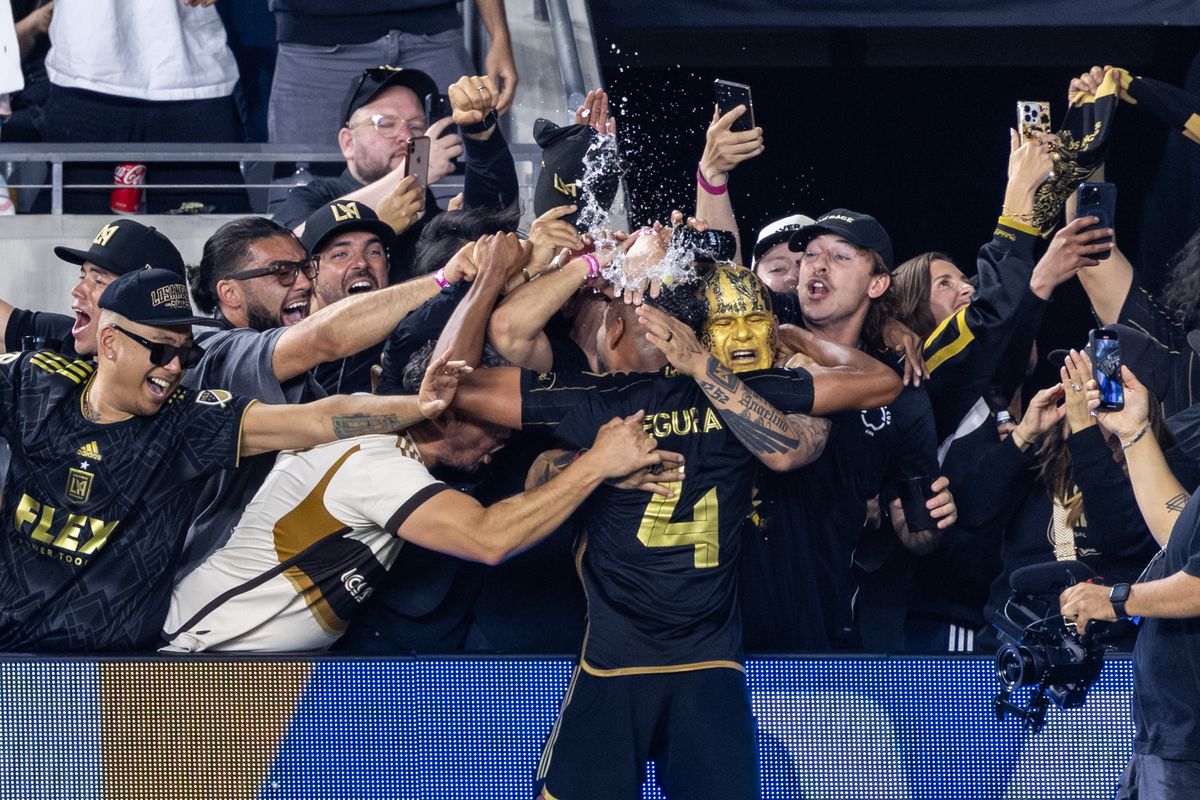 LAFC defender Eddie Segura (4) celebrates the go-ahead goal with LA Rams wide receiver Puka Nacua and other supporters during a FIFA Club World Cup play-in match against Club América, Saturday May 31, 2025 in Los Angeles, Calif.