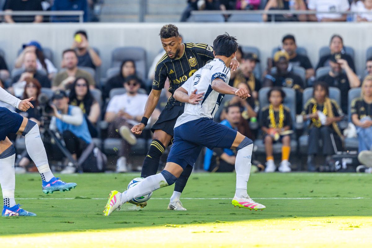 LAFC forward Denis Bouanga (99) has his shot blocked by Vancouver Whitecaps defender Mathías Laborda (2) during an MLS match, Sunday June 29, 2025 in Los Angeles, Calif. LAFC forward Denis Bouanga (99) has his shot blocked by Vancouver Whitecaps defender Mathías Laborda (2) during an MLS match, Sunday June 29, 2025 in Los Angeles, Calif.
