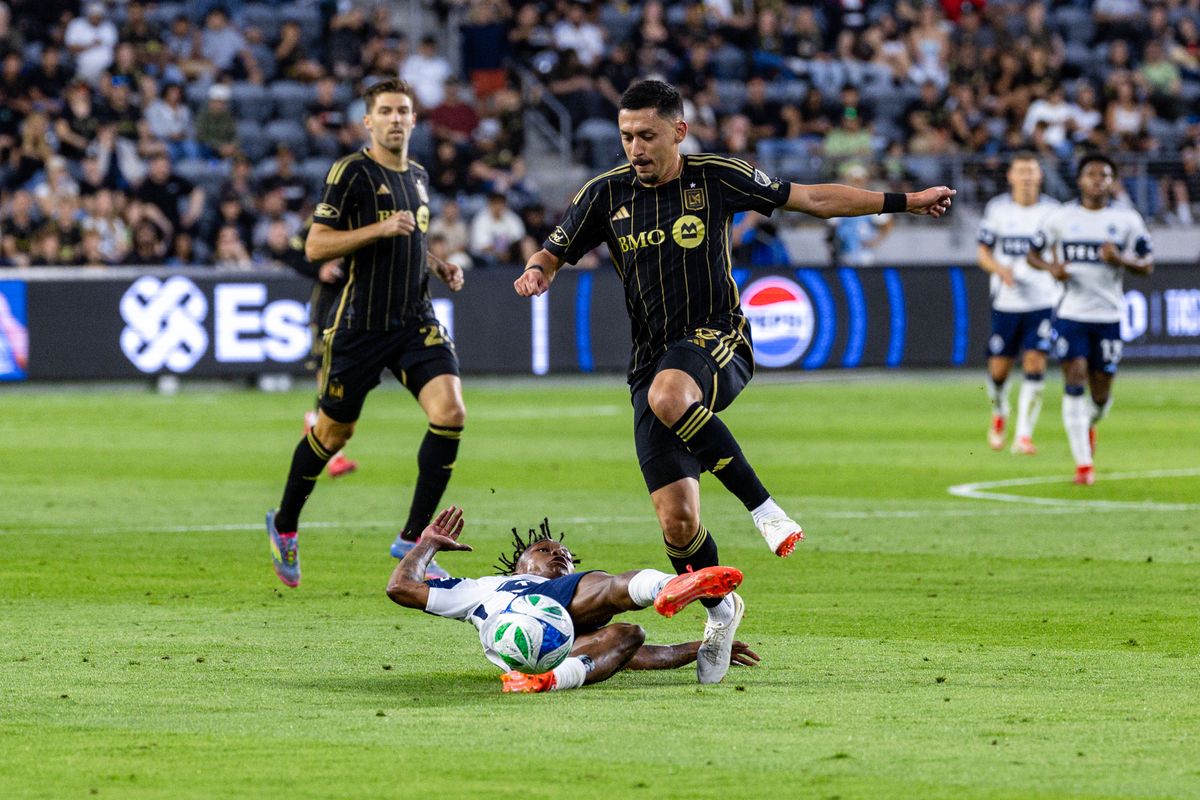 Vancouver Whitecaps defender Édier Ocampo (18) slide tackles LAFC midfielder Marco Delgado (8) during an MLS match, Sunday June 29, 2025 in Los Angeles, Calif. Vancouver Whitecaps defender Édier Ocampo (18) slide tackles LAFC midfielder Marco Delgado (8) during an MLS match, Sunday June 29, 2025 in Los Angeles, Calif.