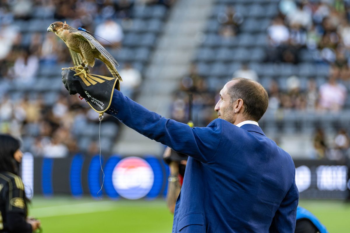 LAFC alum and new member of club ownership Giorgio Chiellini lifts Olly the falcon prior to an MLS match between LAFC and the Colorado Rapids, Wednesday July 9, 2025 in Los Angeles, Calif.
