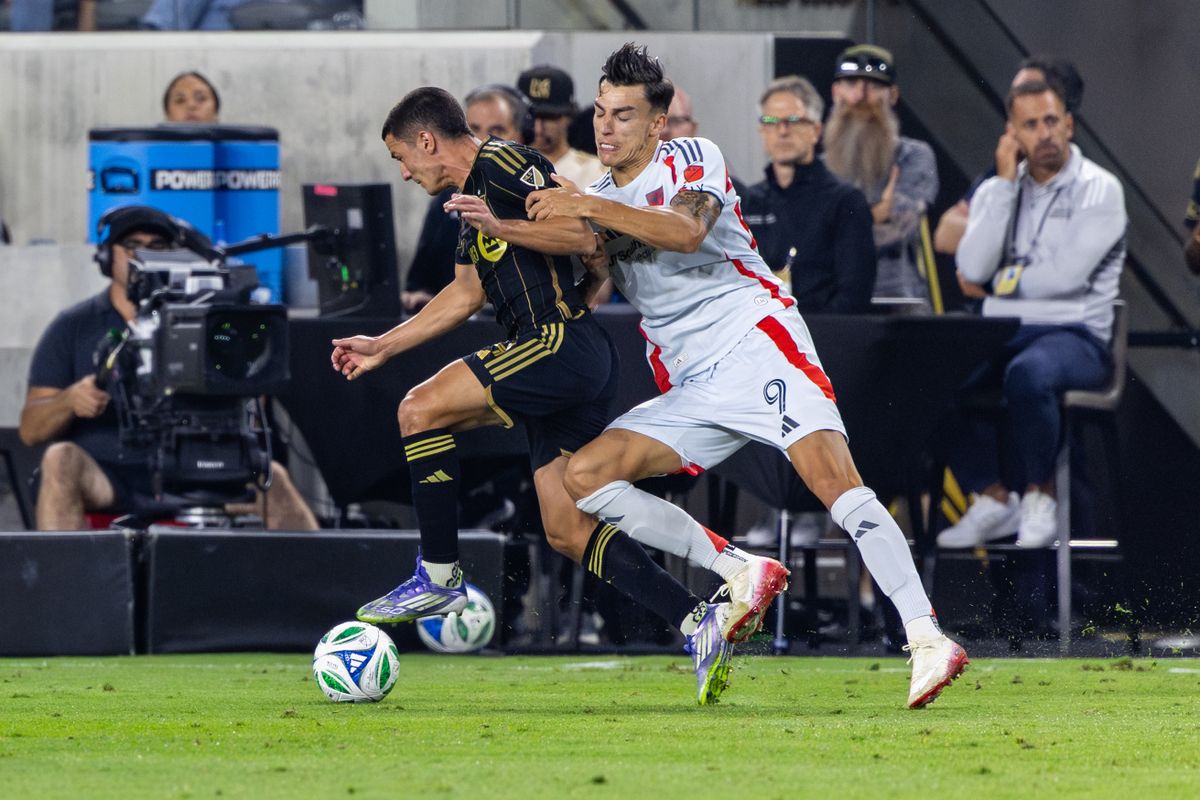 LAFC defender Sergi Palencia (14) battles for a ball with FC Dallas forward Petar Musa (9) during an MLS match, Saturday July 12, 2025 in Los Angeles, Calif.