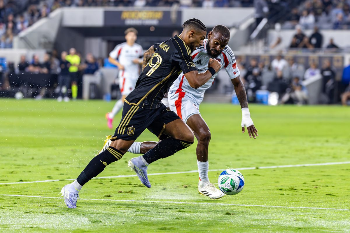 LAFC forward Denis Bouanga (99) and FC Dallas defender Sebastien Ibeagha (25) battle for the ball during an MLS match, Saturday July 12, 2025 in Los Angeles, Calif.