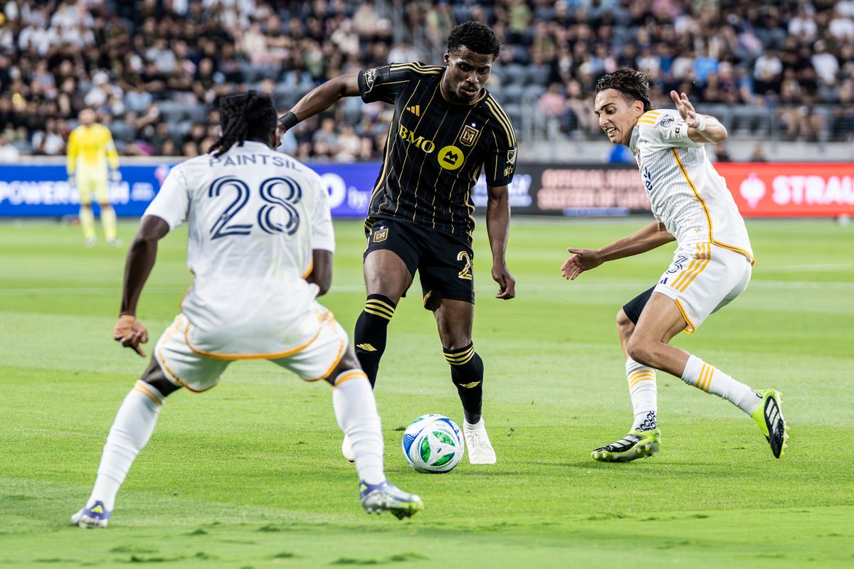 LAFC Midfielder Yaw Yeboah (20) tries to split two defenders in a game against the LA Galaxy, Saturday July 19, 2025 in Los Angeles, Calif.