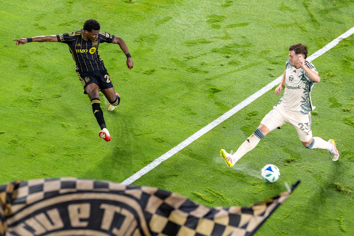 LAFC forward Javairô Dilrosun (26) tries to get a shot past Portland Timbers defender Ian Smith (23) during an MLS match, Friday July 25, 2025 in Los Angeles, Calif.