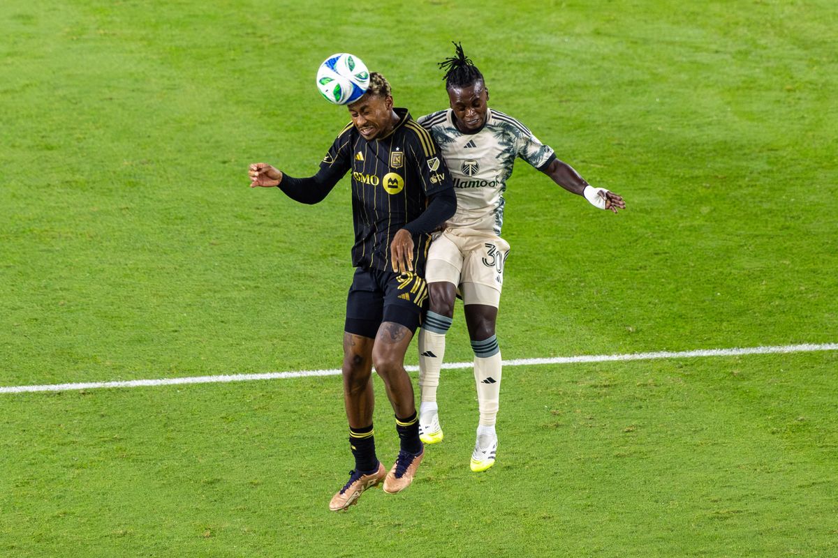 LAFC defender Nkosi Tafari (91) and Portland Timbers midfielder Santiago Moreno (30) go for a ball in flight during an MLS match, Friday July 25, 2025 in Los Angeles, Calif.