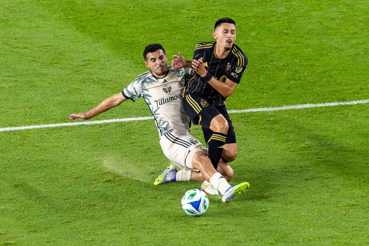 LAFC midfielder Marco Delgado (8) draws a yellow card on Portland Timbers midfielder Cristhian Paredes (17) during an MLS match, Friday July 25, 2025 in Los Angeles, Calif.