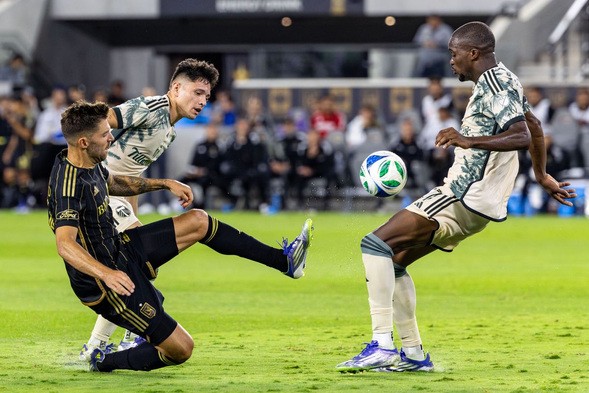 LAFC midfielder Ryan Hollingshead (24) tries to get a shot off during an MLS match against the Portland Timbers, Friday July 25, 2025 in Los Angeles, Calif.