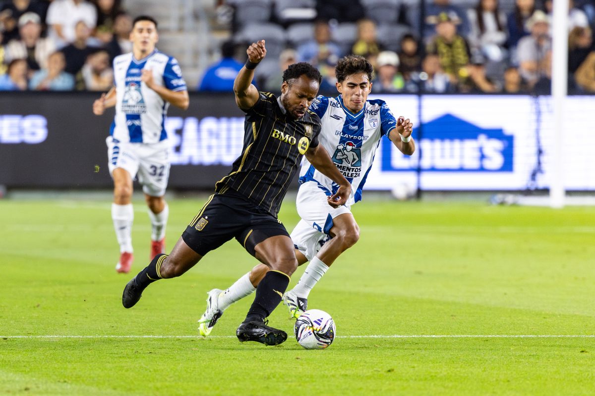 LAFC forward Jeremy Ebobisse (17) pushes the ball upfield against Pachuca midfielder Elías Montiel (28) during a Leagues Cup match between, Friday August 1, 2025 in Los Angeles, Calif.
