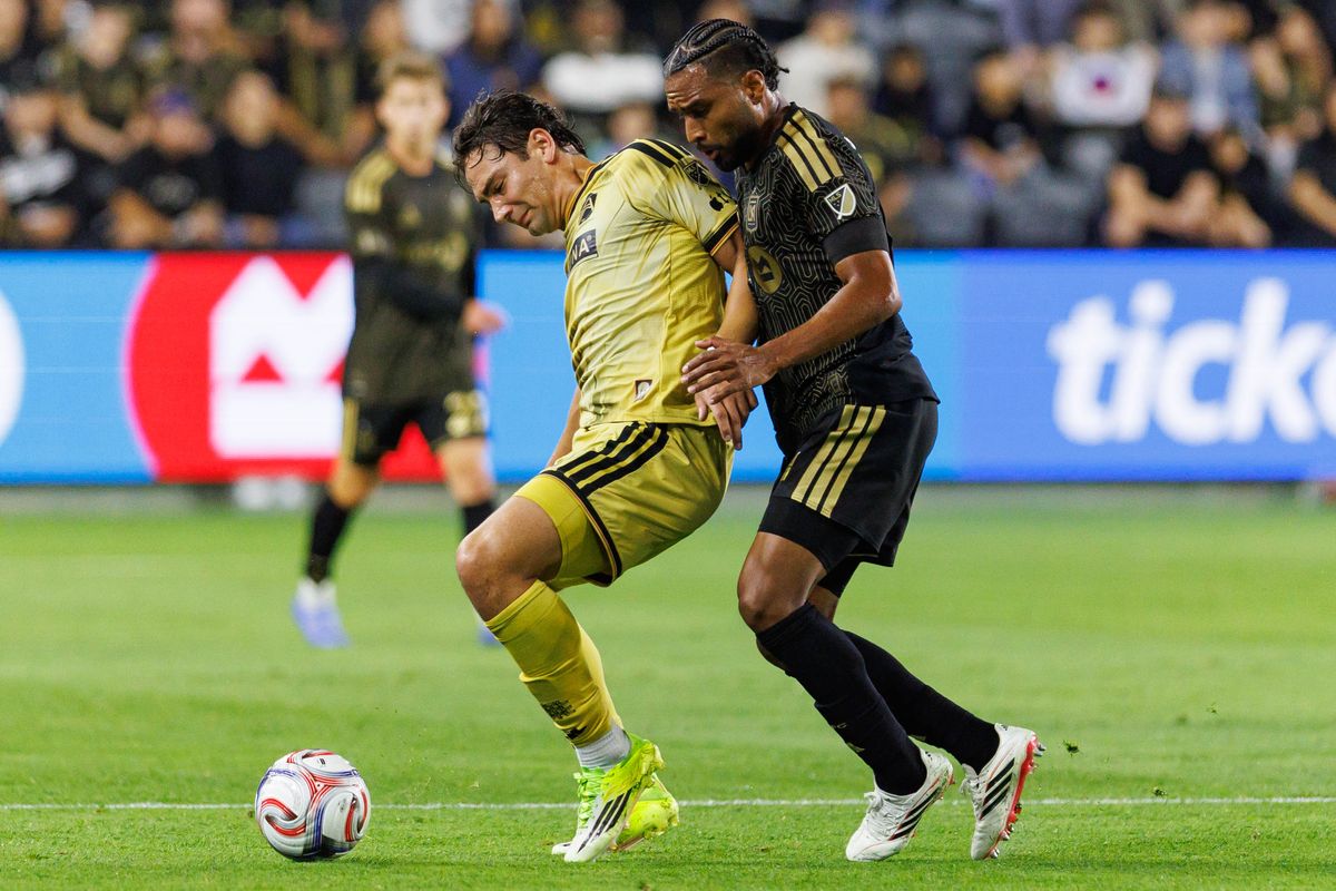 St. Louis FC forward Simon Becher (#11) defends the ball from LAFC defender Eddie Segura (#4) during an MLS match against LAFC on March 14, 2026 in Los Angeles, California.