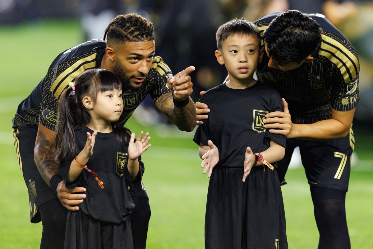LAFC forward Denis Bouanga (#99) and forward Son Heung-Min (#7) interacts with fans before an MLS match against St. Louis FC on March 14, 2026 in Los Angeles, California.